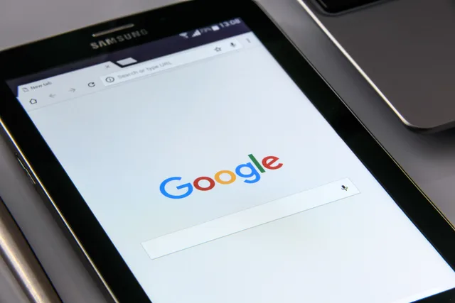 Close-up of a tablet displaying Google's search screen, emphasizing technology and internet browsing. Affiliate-tracking